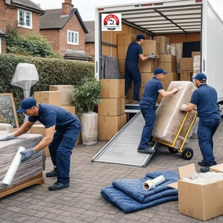 BBC Moving crew loading a truck with padded furniture